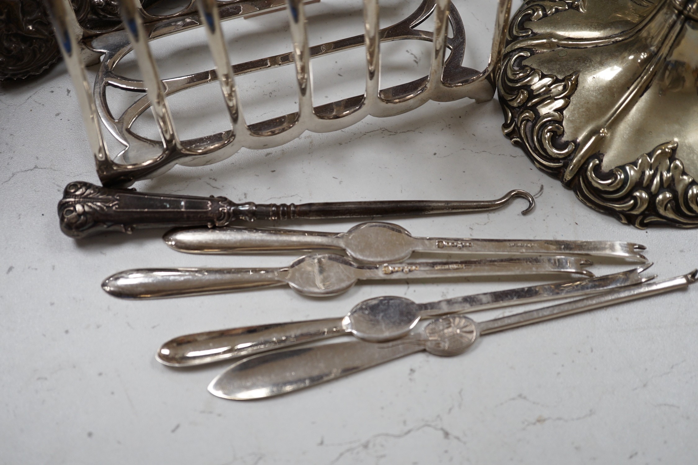 A pair of embossed silver photograph frames and plated wares